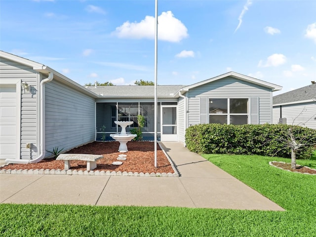 property entrance featuring a garage and a yard