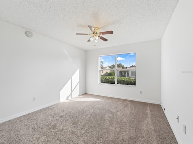 unfurnished room featuring a textured ceiling, carpet flooring, and ceiling fan