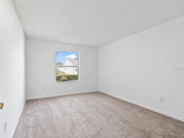 carpeted spare room featuring a textured ceiling