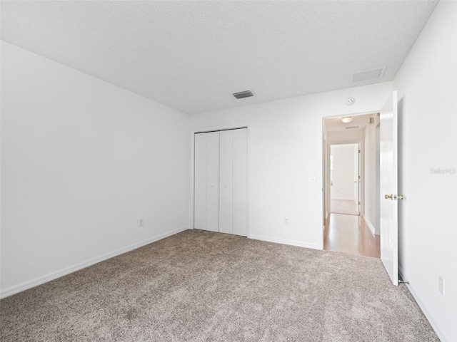 unfurnished bedroom with carpet floors and a closet