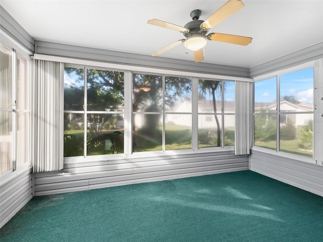 unfurnished sunroom featuring ceiling fan