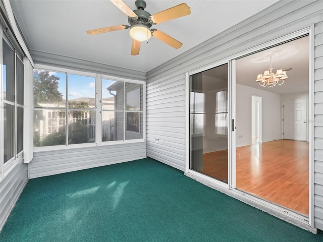 unfurnished sunroom with ceiling fan with notable chandelier