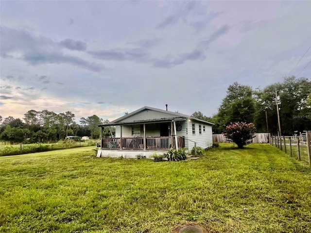 rear view of property featuring a yard