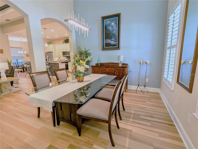 dining area featuring a chandelier and light hardwood / wood-style flooring