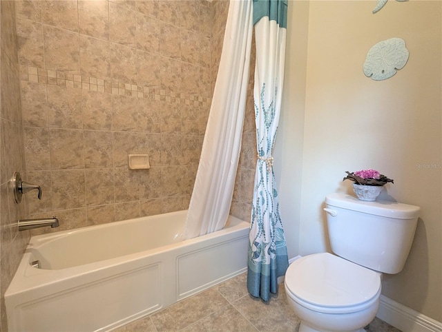 bathroom featuring shower / bath combo with shower curtain, toilet, and tile patterned flooring