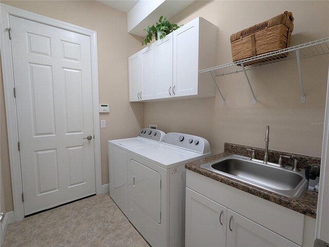 laundry area with cabinets, sink, and separate washer and dryer