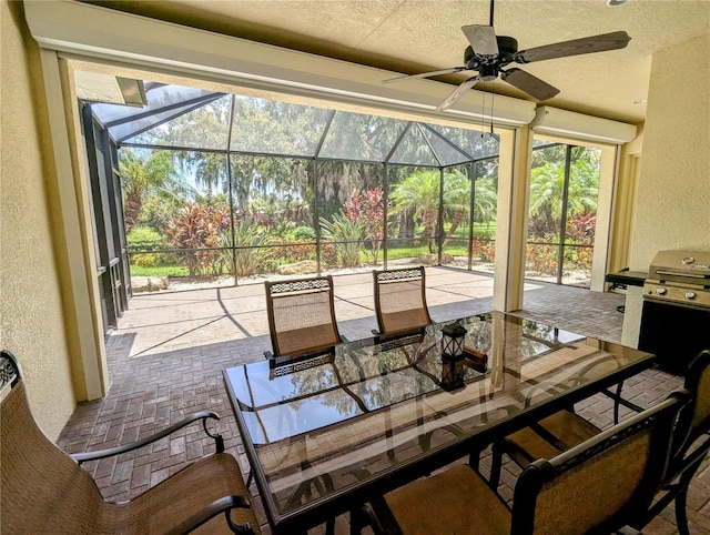 view of patio / terrace with ceiling fan and glass enclosure