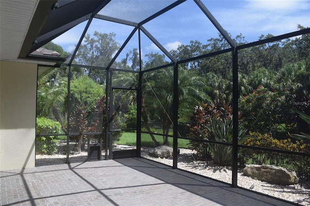 view of patio / terrace featuring a lanai