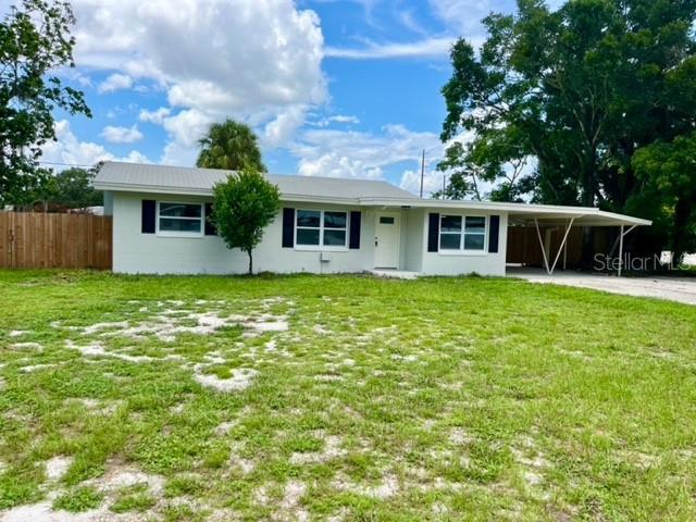 ranch-style home with a front lawn