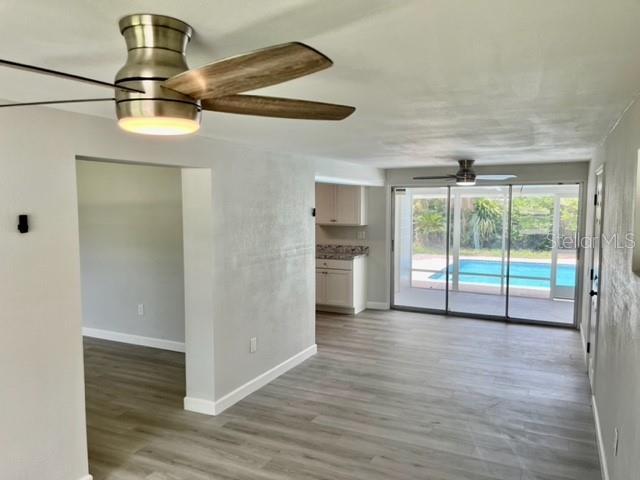 unfurnished room featuring ceiling fan and wood-type flooring