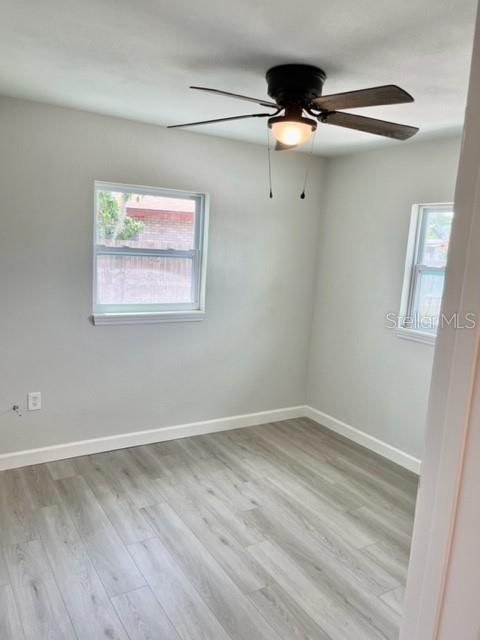 empty room featuring light hardwood / wood-style flooring and ceiling fan