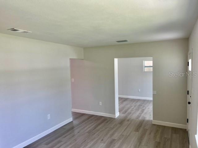 empty room with hardwood / wood-style flooring