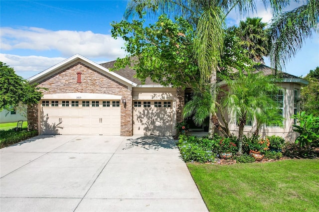 view of front of home with a front yard and a garage