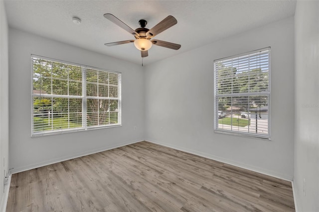 empty room featuring ceiling fan and light wood-type flooring