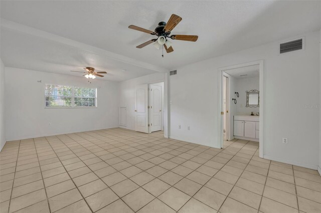 unfurnished room with light tile patterned flooring and ceiling fan