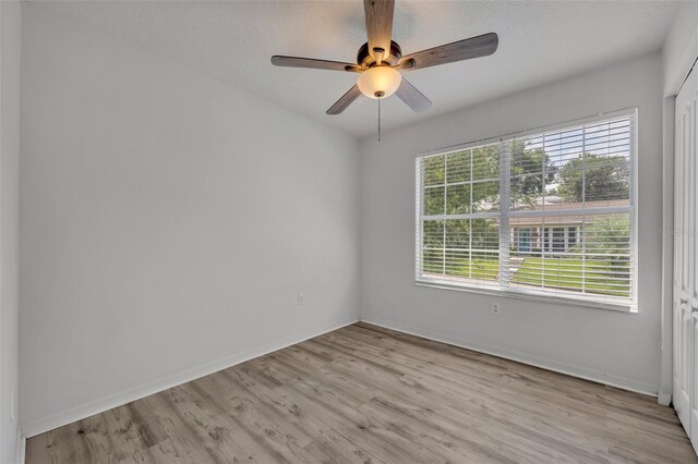 empty room featuring ceiling fan and light hardwood / wood-style floors