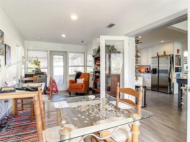 living room featuring a textured ceiling and hardwood / wood-style floors