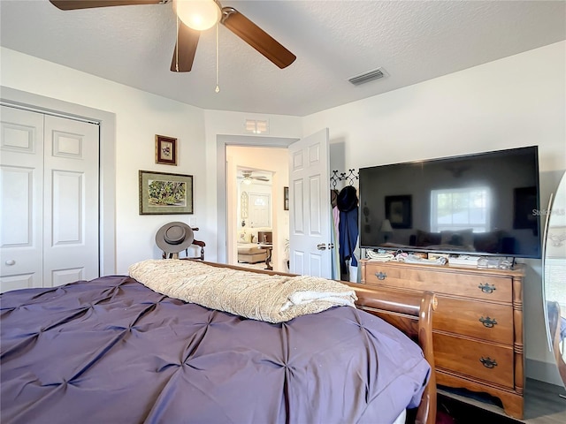 bedroom with ceiling fan and a closet