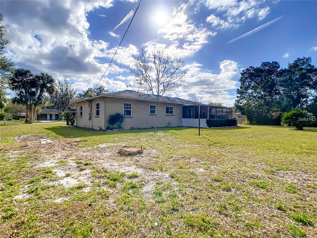 back of house with a lawn