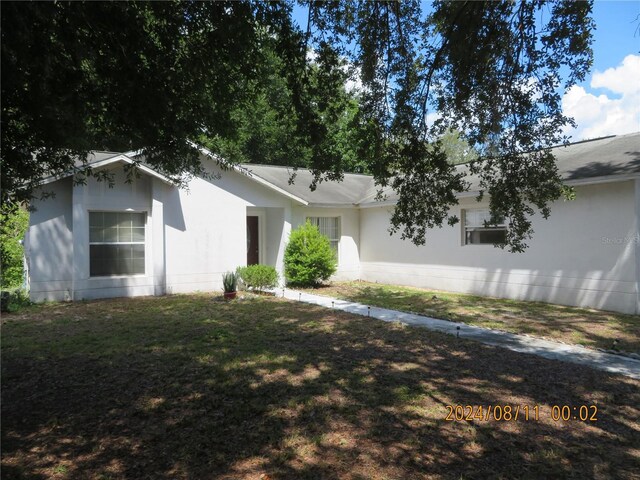 ranch-style home with a front lawn