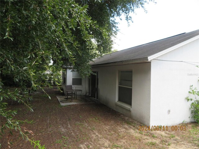 view of property exterior with a patio area