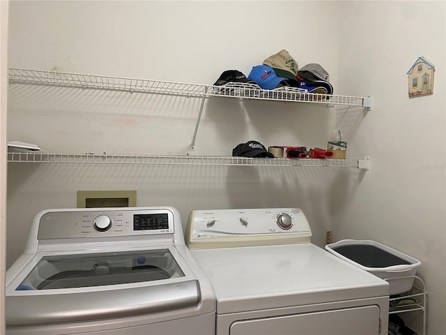 clothes washing area featuring washing machine and clothes dryer