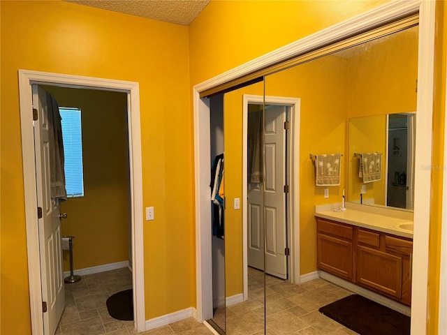 bathroom with vanity and a textured ceiling