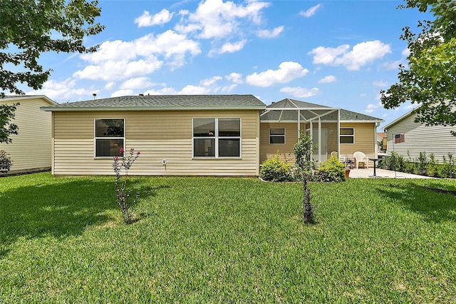 back of property featuring a lanai, a lawn, and a patio area