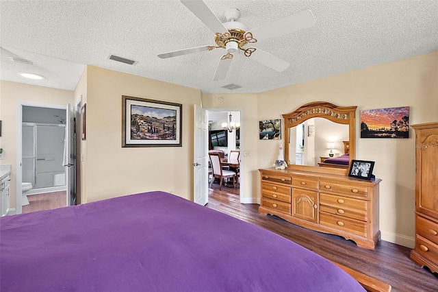 bedroom featuring ceiling fan, dark hardwood / wood-style flooring, ensuite bathroom, and a textured ceiling