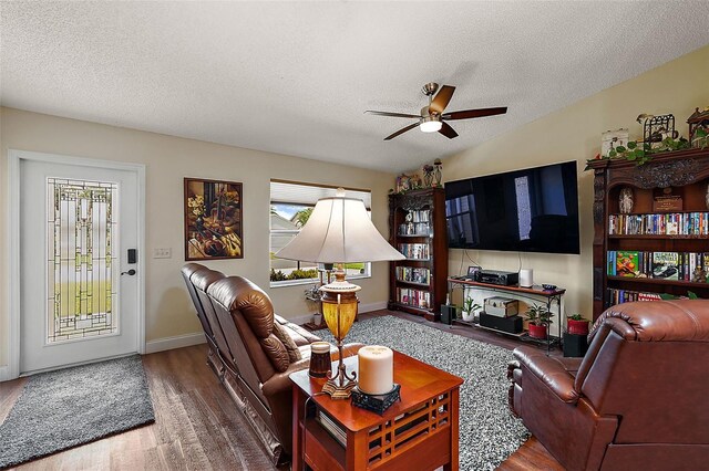 living room with ceiling fan, a textured ceiling, and hardwood / wood-style flooring