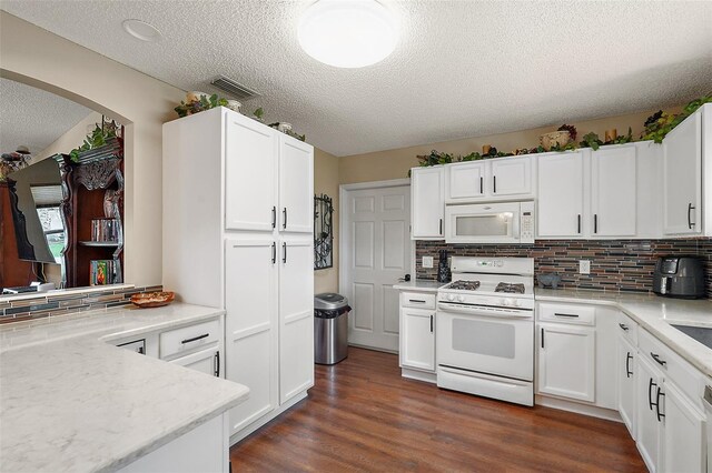 kitchen featuring white cabinets, white appliances, dark hardwood / wood-style floors, and decorative backsplash