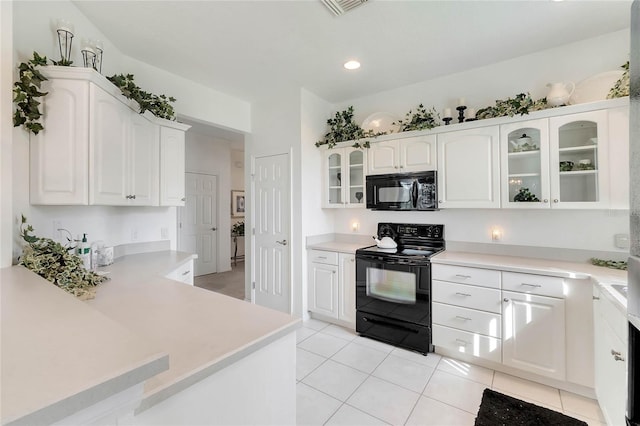 kitchen featuring black appliances, white cabinetry, kitchen peninsula, and light tile patterned floors