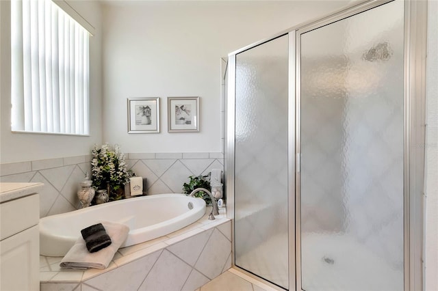 bathroom with shower with separate bathtub, plenty of natural light, and vanity