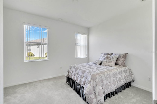 bedroom featuring light colored carpet