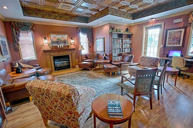 interior space featuring light hardwood / wood-style flooring, a raised ceiling, and ornamental molding