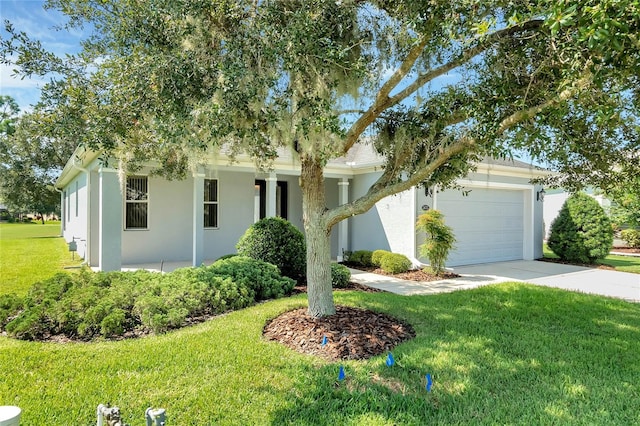 view of front of home with a garage and a front yard