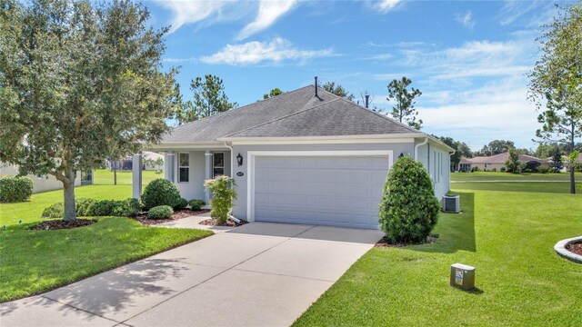 ranch-style home with a front lawn, cooling unit, and a garage