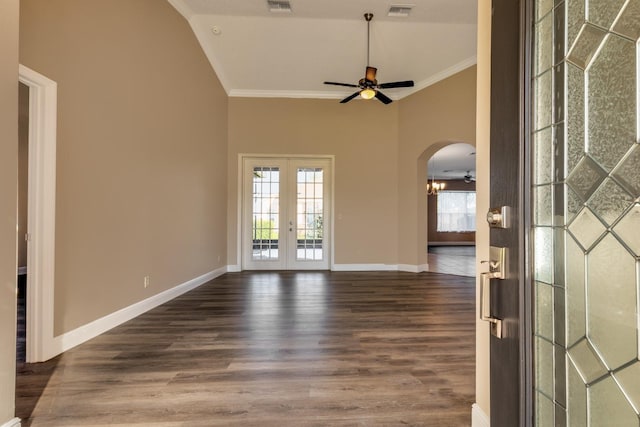 spare room with arched walkways, french doors, visible vents, and crown molding