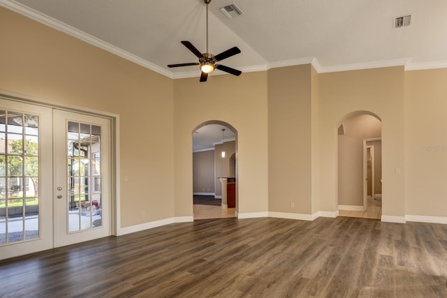 spare room with a high ceiling, french doors, crown molding, dark hardwood / wood-style floors, and ceiling fan