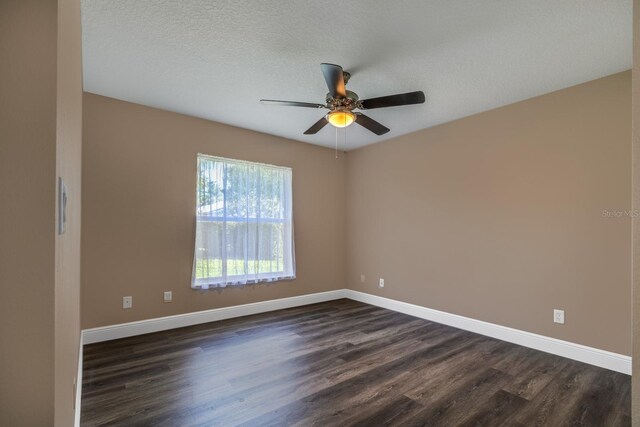 empty room featuring a textured ceiling, ceiling fan, and dark hardwood / wood-style floors