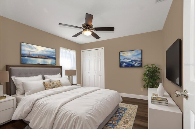 bedroom featuring ceiling fan, a closet, and dark wood-type flooring