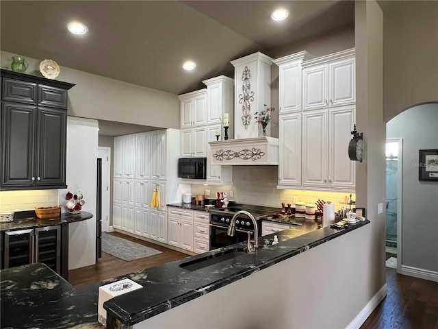 kitchen with white cabinets, sink, wine cooler, dark wood-type flooring, and tasteful backsplash