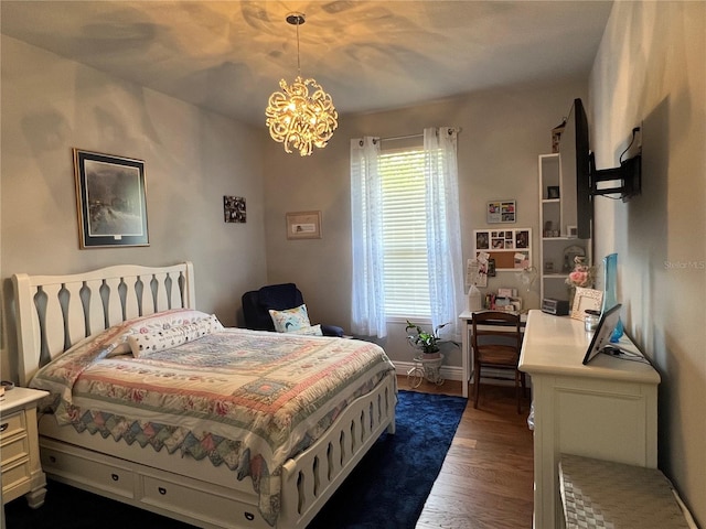 bedroom with dark hardwood / wood-style flooring and an inviting chandelier