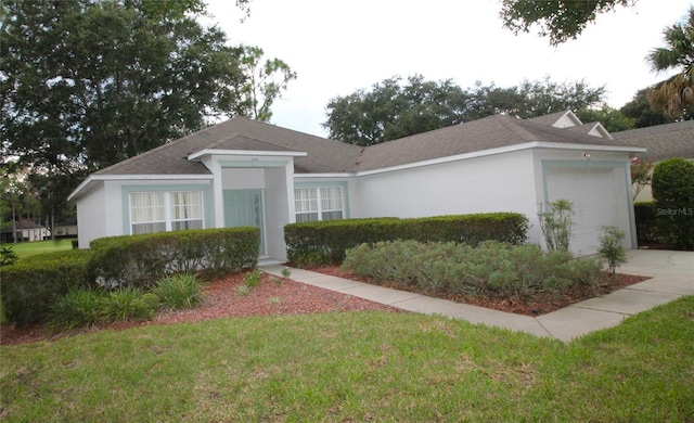 single story home featuring a garage and a front yard