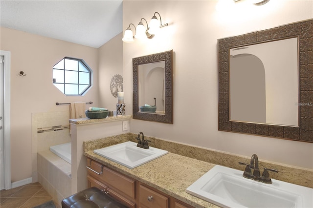 bathroom featuring a bath, tile patterned floors, double vanity, and a sink