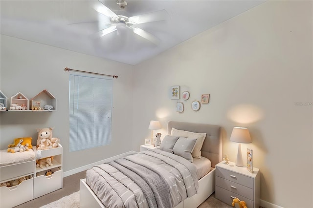 carpeted bedroom with a ceiling fan and baseboards