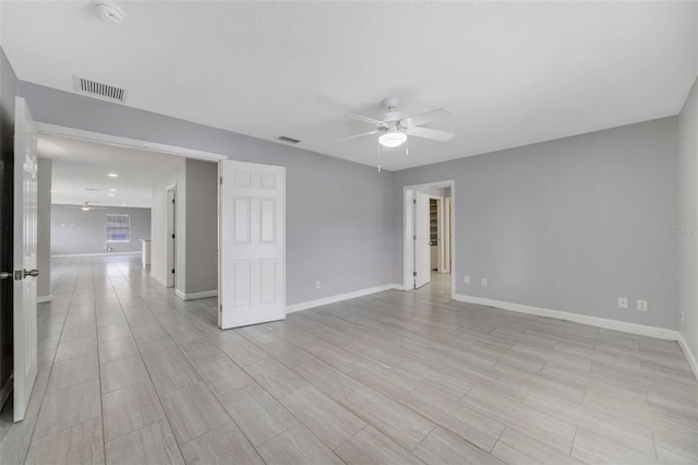 unfurnished room featuring ceiling fan and light hardwood / wood-style flooring