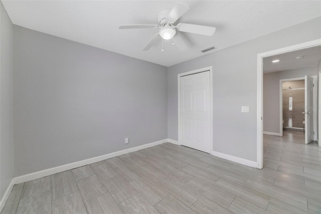 unfurnished bedroom featuring ceiling fan and a closet