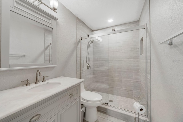 bathroom featuring toilet, vanity, an enclosed shower, and hardwood / wood-style flooring