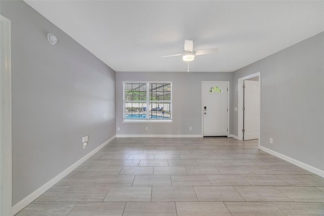 interior space with ceiling fan